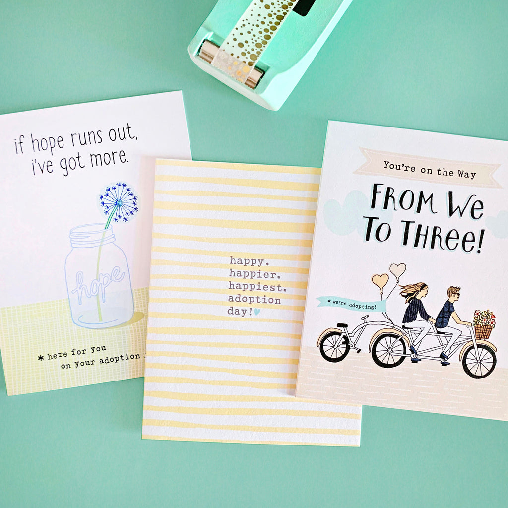 Photo of greeting cards for adopting families. Three cards featured, one for beginning the adoption journey, one for hope along the way and one celebrating a happy adoption.