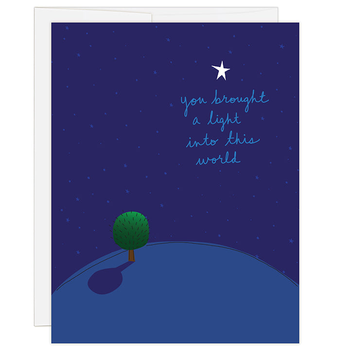 4.25 x 5.5 inch adoption greeting card for a birth mother or birth father. Blank inside. Simple illustration style. Title You Brought A Light Into This World. Main image of dark blue background with an illustration of a small green tree on a small earth with one bright white star above title.