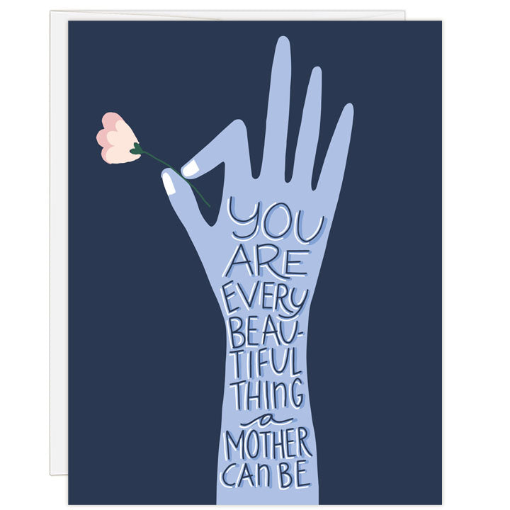 Illustrated greeting card in deep blue and lavender. Artful hand holding a pink flower. Mother's Day card for any mother. Message: you are every beautiful thing a mother can be.