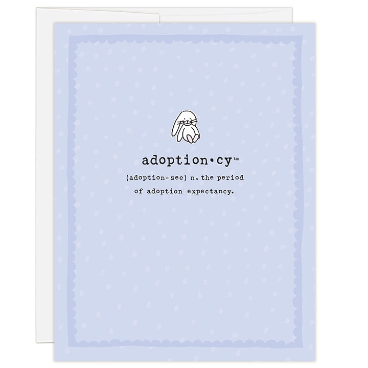 4.25 x 5.5 inch greeting card. Blank inside. Simple and charming illustration style. Title Adoptioncy (adoption-see) n. the period of adoption expectancy. Lavender background with light purple dots. Main image is a small white bunny rabbit. 