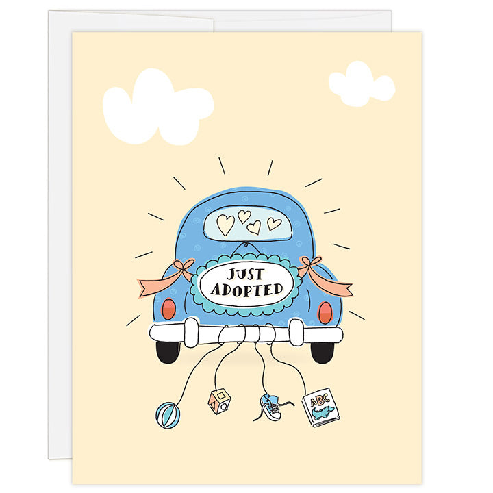 4.25 x 5.5 inch adoption celebration greeting card. Blank inside. Simple and charming illustration style. Sign on back of a dark blue antique car that reads JUST ADOPTED. Strings hang from the back bumper of the car with a ball, wooden block, toddler tennis show and abc’s baby book.