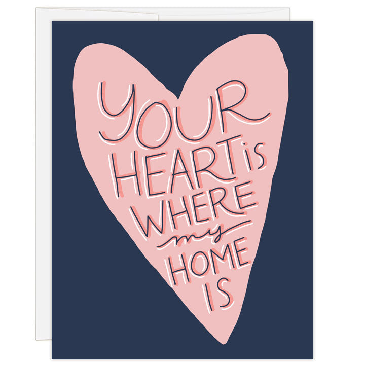 Bold blue and pink art with illustrated heart, this Mother's Day card says: your heart is where my home is in hand drawn text.
