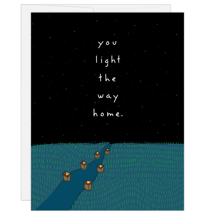 4.25 x 5.5 inch greeting card. Blank inside. Cover features line illustration of a path lit by luminaries beneath a blue-black star-filled sky. Text reads: you light the way home.