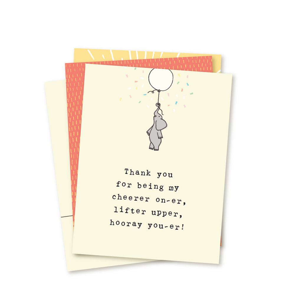Stack of four adoption greeting cards included in a 4-card gratitude set. Top card shows simple hand-drawn elephant being lifted by a balloon with falling confetti. Typewritten title reads Thank you for being my cheerer on-er, lifter upper, hooray you-er! The other three cards of the set peek out behind top card.